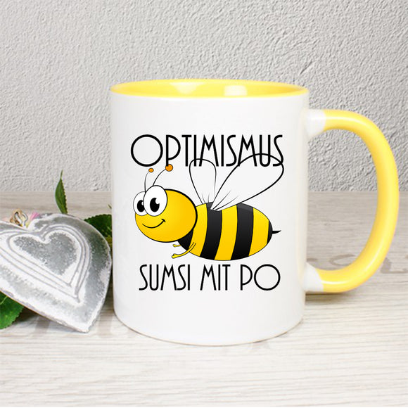 weiße Tasse innen gelb und gelber Henkel Optimismus Biene Sumsi mit Po 