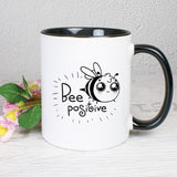 Tasse Weiß/Schwarz bedruckt mit Spruch: Bee positive mit Biene