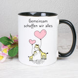 Tasse Weiß/Schwarz bedruckt mit Spruch: Gemeinsam schaffen wir alles mit Giraffen. 