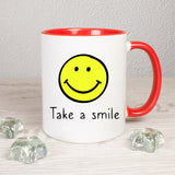 Tasse Weiß/Rot mit Smiley und Spruch bedruckt: Take a smile