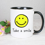 Tasse Weiß/Schwarz mit Smiley und Spruch bedruckt: Take a smile